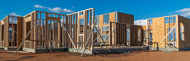 Apartment building under construction showing the foundation and framing