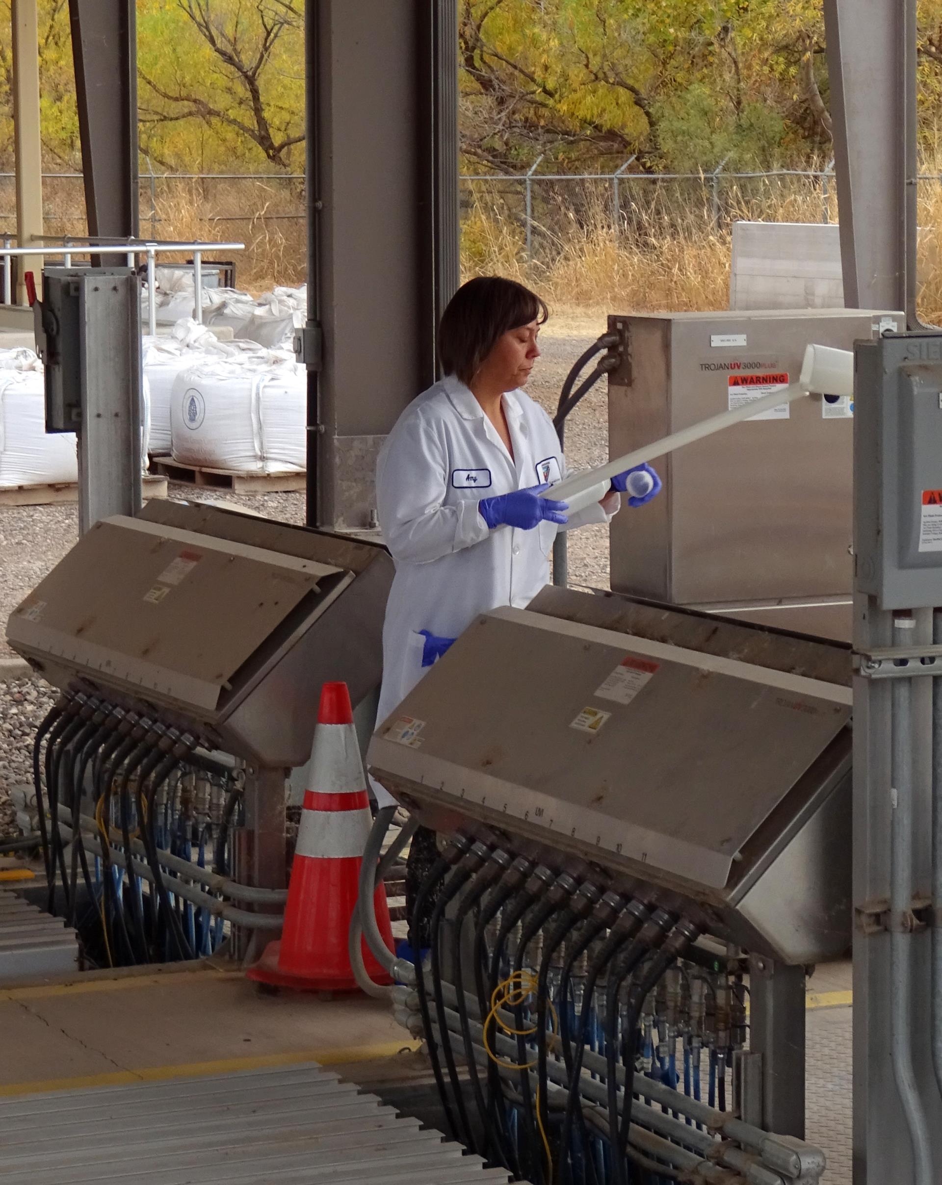 A lab technician collects samples at the facility.